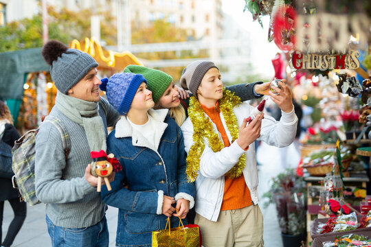 Family With Two Teenagers Having Fun On Christmas Market. High Quality Photo