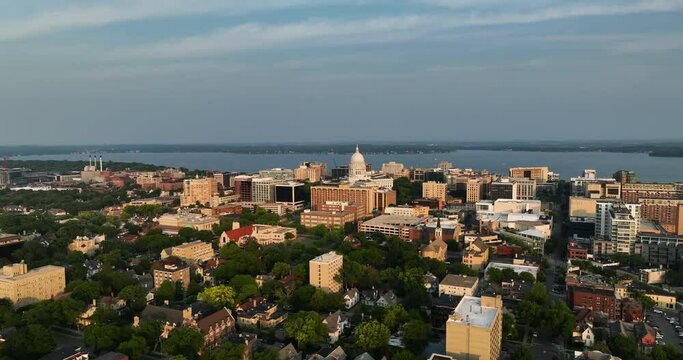 Wide angle aerial shot of madison downtown buildings and green areas surrounding the city, wisconsin
