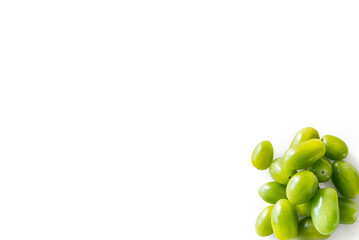 Closeup of fresh juicy organic green cherry tomatoes from the garden isolated on a white background from above, top view