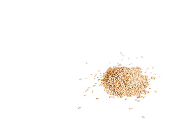 Closeup organic whole raw sesame seeds isolated on a white background
