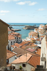 The small European village of Cudillero. These bright houses and beautiful seaside town is beautiful and colorful during the winter. The ocean next to the white buildings creates a stunning landscape.