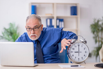Old male employee in time management concept
