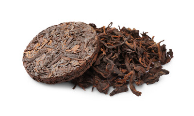 Disc shaped traditional Chinese pu-erh tea and leaves isolated on white