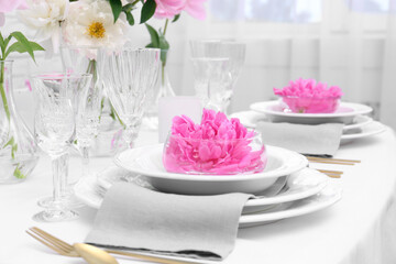 Fototapeta na wymiar Stylish table setting with beautiful peonies in dining room, closeup