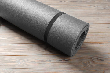 One grey yoga mat on wooden floor