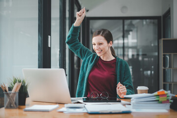 Fototapeta premium Businesswoman happy and cheerful for successful on project via laptop in office space.
