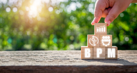 BPM, Business Process Management concept, Hand holding wooden block with business process...