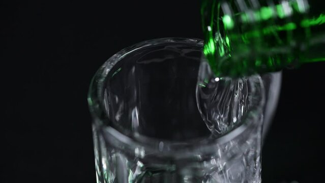 Slow motion pouring traditional Korean liquor Soju