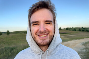 happy man in the field in summer at sunrise or sunset, enjoying nature