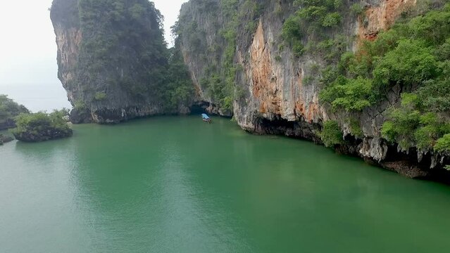Aerial view amazing Panak island has a cave entrance into the canyon. .Visitors can take a canoe boat to see the big mangrove up in the valley..Panak island is the one landmark of Phang Nga Thailand