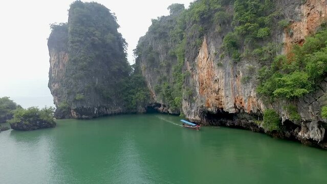 Aerial view amazing Panak island has a cave entrance into the canyon. .Visitors can take a canoe boat to see the big mangrove up in the valley..Panak island is the one landmark of Phang Nga Thailand