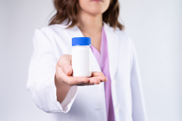 medication mock up bottle on the pharmacist or doctor's hand.