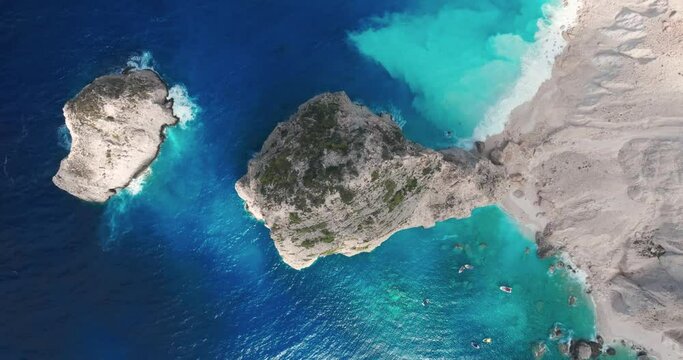 Birdseye Aerial View of Secluded Beach and Rocks in Blue Sea Water. Zakynthos Island, Greece 50fps