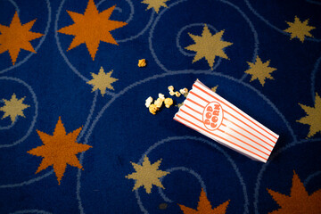 Popcorn and film strip on the blue background.