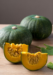 Green pumpkin on wooden with black background, Organic vegetable in autumn season