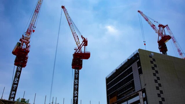 A timelapse of crane at the top of the building at the business town in Tokyo zoom