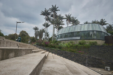 Architectural Elegance Amidst Nature: Decorative architectural elements harmonize with lush plants, vibrant flowers, and green vegetation. The fusion of man-made beauty and natural grace creates a cap