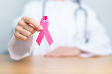 Pink October Breast Cancer Awareness month, woman doctor with pink Ribbon in hospital for support...