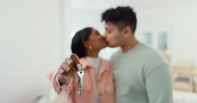 Hands, couple and kiss with keys in new home for moving, real estate investment or security for future. Closeup, people or celebrate key to house rental, property building or finance of mortgage loan