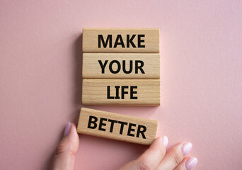 Make your Life Better symbol. Concept word Make your Life Better on wooden blocks. Beautiful pink...