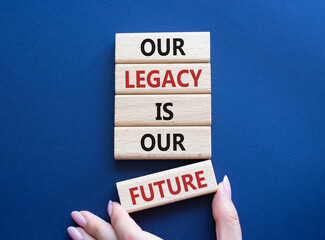 Our Legacy is our Future symbol. Concept words Our Legacy is our Future on wooden blocks. Businessman hand. Beautiful deep blue background. Business and Our Legacy is our Future concept. Copy space