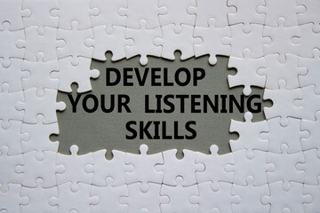 Listening skills symbol. Concept word Develop active listening skills on white puzzle. Beautiful...