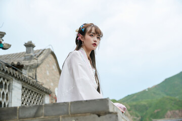 An Oriental beauty in ancient attire holding an umbrella