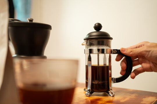 A man making french press coffee