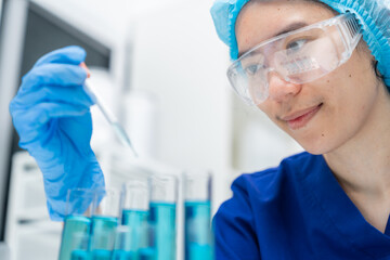 Fototapeta premium laboratory glassware equipment for medicals science chemistry research, blue liquid in scientific glasses flask, test tube, and beaker for chemical medicine experiment or biology technology analysis