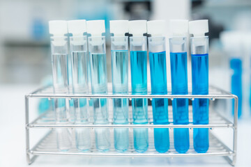 laboratory glassware equipment for medicals science chemistry research, blue liquid in scientific glasses flask, test tube, and beaker for chemical medicine experiment or biology technology analysis