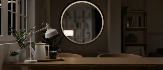 Copy space on a wooden dining table in a modern contemporary dining room at night.