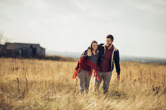 Young caucasian couple walking together in the countryside