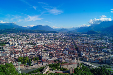 Aerial view of Grenoble old town seen from Bastille Fort, Auvergne-Rhone-Alpes region, France, Europe. View from above on the Isere Valley in the French Pre-Alps. Chartreuse Belledonne mountain range