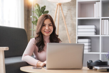 Young asian woman having conversation chatting while using laptop at house. Work at home, Video conference, Online meeting video call, Virtual meetings, Remote learning and E-learning