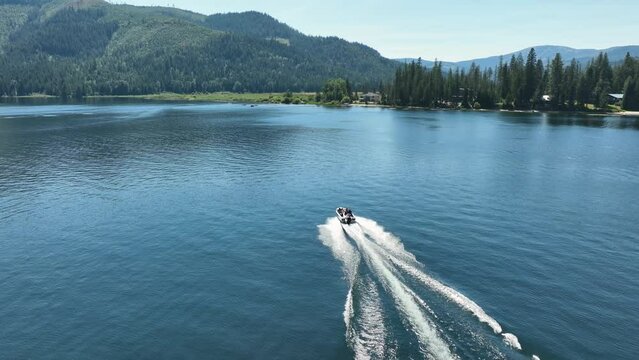 Drone shot of a motorboat traveling through Spirit Lake in Idaho.