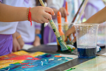 Children and friends paint with their own creativity in colorful colors in kindergarten class in...