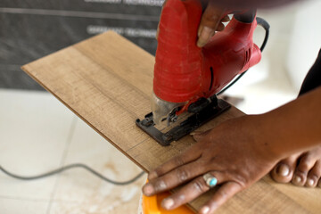 worker joining vinyl floor covering at home renovation