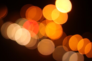 A black background with a golden light bokeh effect. 