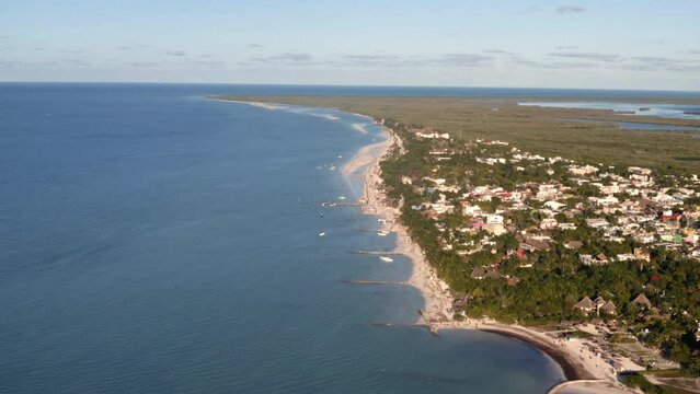 Caribbean coastline with small town and sandy beaches in Mexico.
