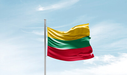 Lithuania national flag waving in beautiful sky. The symbol of the state on wavy silk fabric.