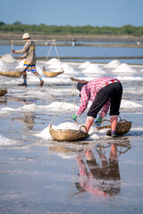 Local people working on the salt flats in Phetchaburi, Thailand, Asia