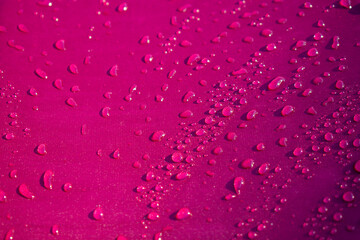 Close up water drop on the pink fabric. Abstract water drop on pink fabric background.