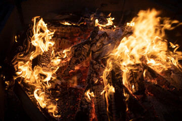 Flames of pyre. Yellow light. Firewood burning in fire.