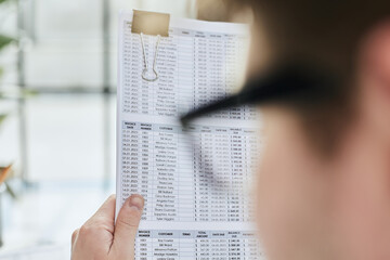 Naklejka premium A male manager is reviewing marketing reports for the new campaign