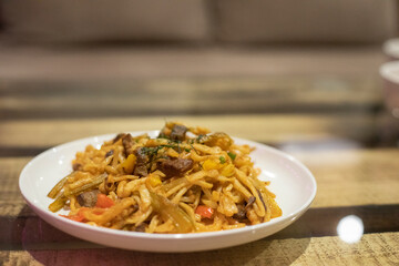 Food in restaurant. Delicious dish in white plate. Dinner on plate.