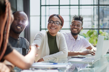 Fototapeta premium African american hr team welcoming female applicant at job interview