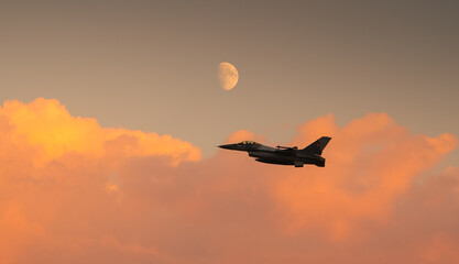 Bucharest International Air Show. F16 military fighter airplane flying under the moon. Military...