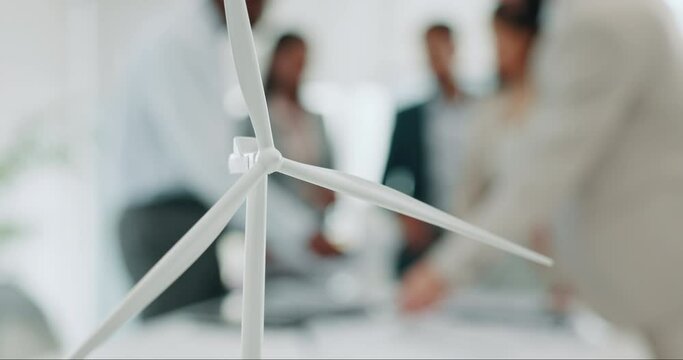 Business people, meeting and windmill for eco friendly, sustainability and renewable energy planning in office. Wind turbine model, design and engineering team with documents in agriculture solution