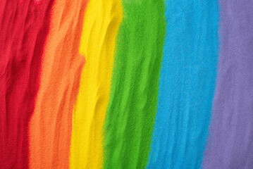 Sand flag embodies LGBT history month support. Top view displays a rainbow sand flag, including an open space for empowering and affirming words - obrazy, fototapety, plakaty