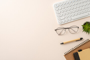 Workspace arrangement idea. Top view of keyboard, planner, notepad, pen, flowerpot, glasses on a...